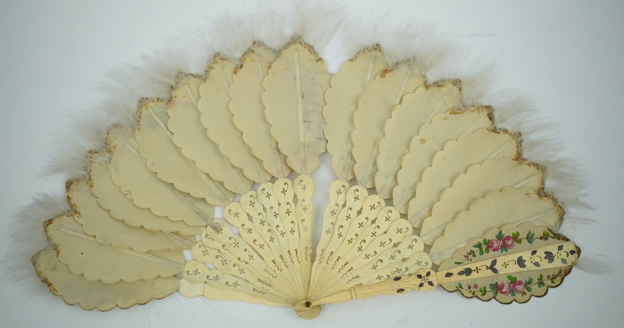 Three French fans: a mother of pearl and sequin fan boxed, a painted silk, feather and bone fan and a gilt decorated bone figural paper fan, the two bone fans having gilt mirrored mounts on the guards, figural paper fan